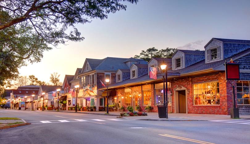Small town street with lit shops Falmouth, MA