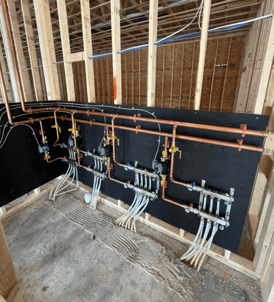 Copper manifold system for radiant floor heating in new construction gallery.
