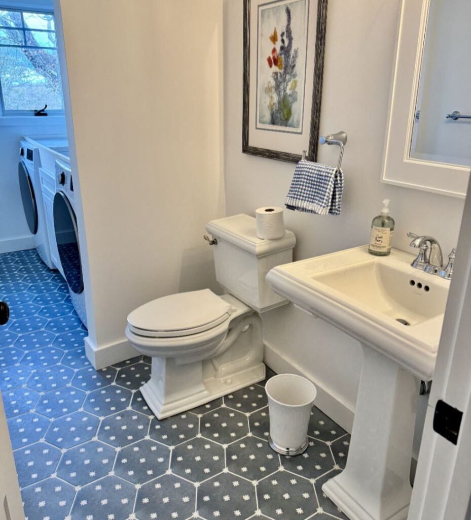 Modern bathroom gallery with pedestal sink, toilet, and hexagonal tile floor.