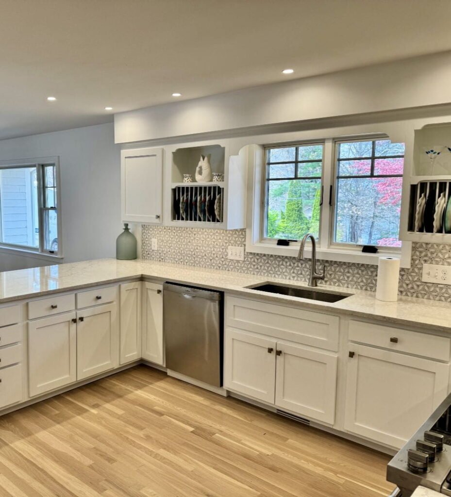 Modern white kitchen gallery with granite countertops and stainless steel appliances.