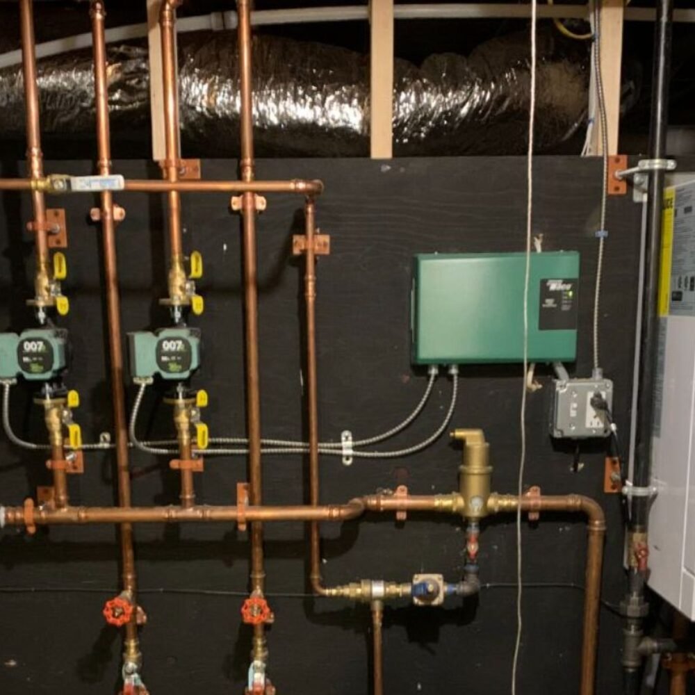Copper plumbing, boiler, and green circulator pump system