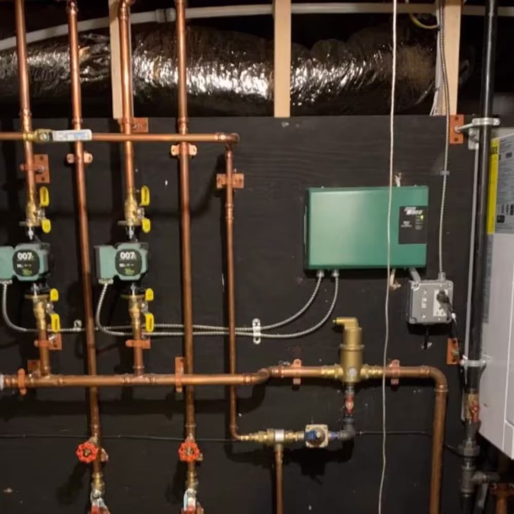 Home plumbing system with boiler, pumps, and copper pipes