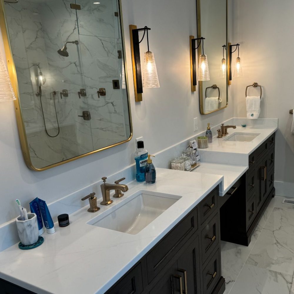 Modern double sink bathroom with brass fixtures