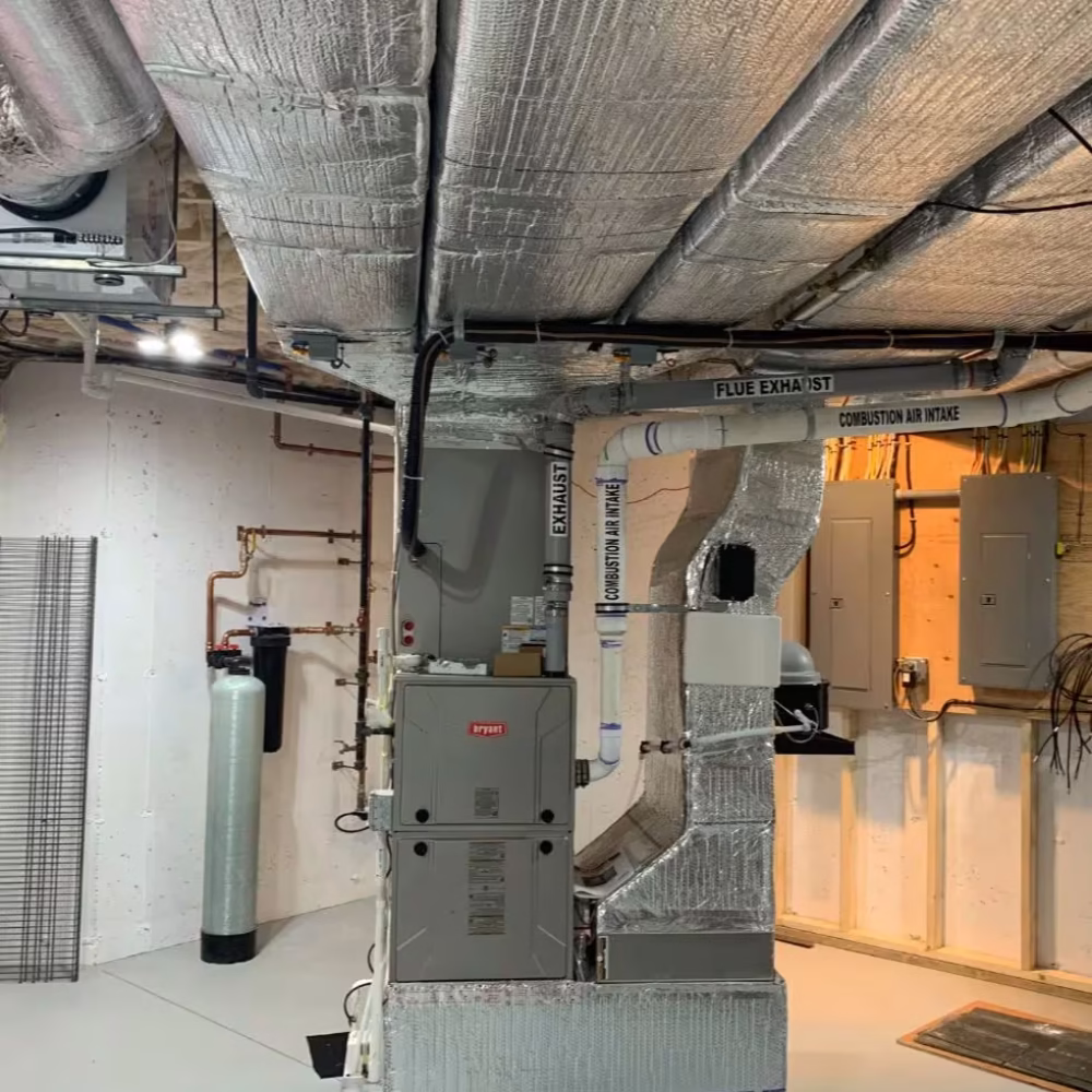 Bryant furnace and plumbing system in a home's utility room.