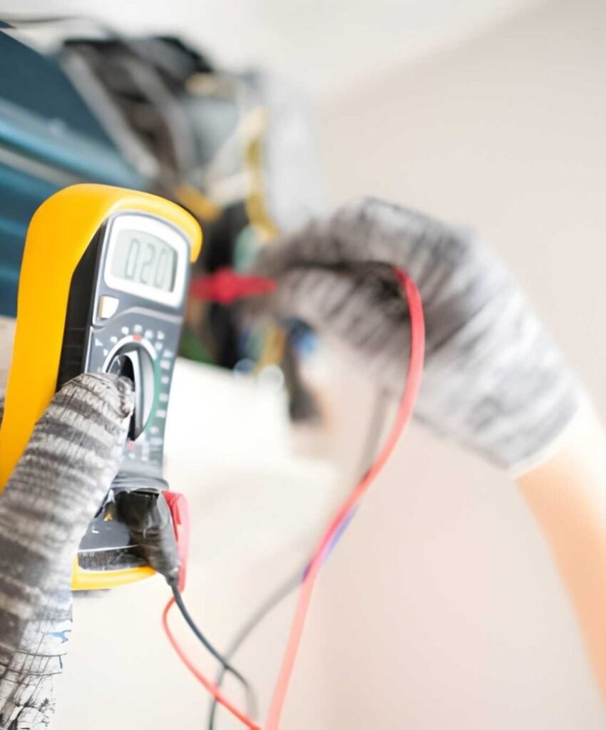 Technician testing AC unit with multimeter.