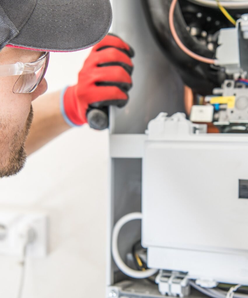 Technician repairing electrical panel with tools